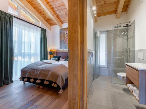 a bedroom with a bed and a shower and a bathroom at Chalet Kolibri in Sankt Lambrecht