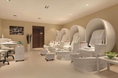 a bathroom with a bunch of sinks and toilets at Radisson Hotel & Conference Centre Calgary Airport in Calgary