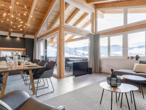 a living room with a couch and a table at Grebenzen Top Chalet Mazzel in Sankt Lambrecht