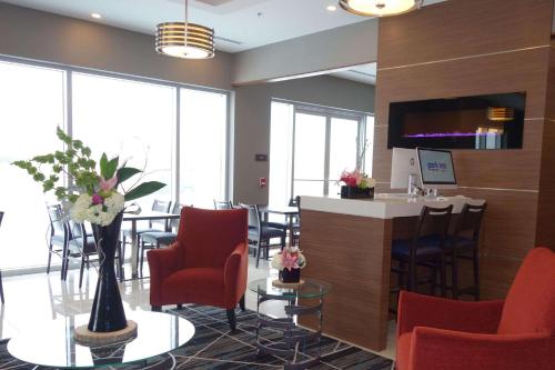 a lobby with a bar with chairs and a table at Park Inn by Radisson Brampton, ON in Brampton