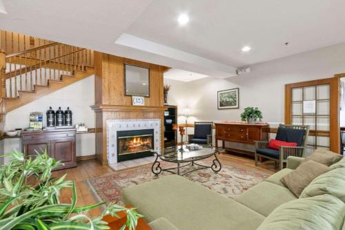 a living room with a couch and a fireplace at Country Inn & Suites by Radisson, Greeley, CO in Greeley