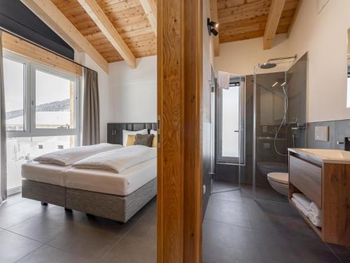a bedroom with a bed and a shower and a bathroom at Alpenchalet Lambert in Sankt Lambrecht