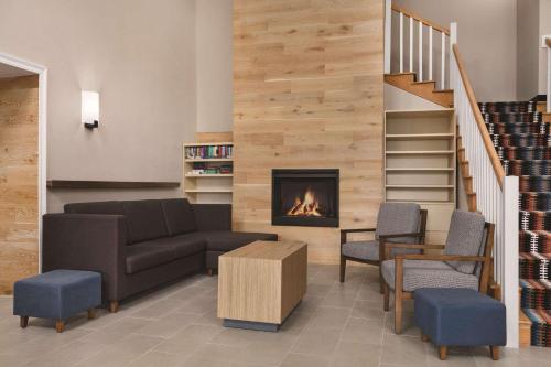 a living room with a couch and a fireplace at Country Inn & Suites by Radisson, Panama City, FL in Panama City