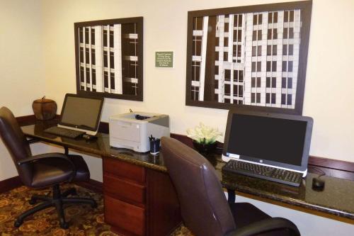 an office with a desk with two computers on it at Country Inn & Suites by Radisson, Port Orange-Daytona, FL in Port Orange