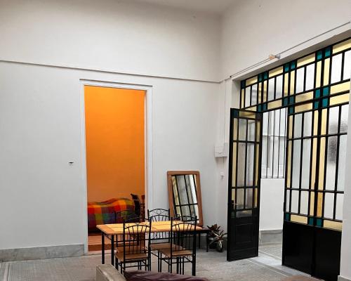 a room with two tables and stained glass windows at Morada Montevideana in Montevideo
