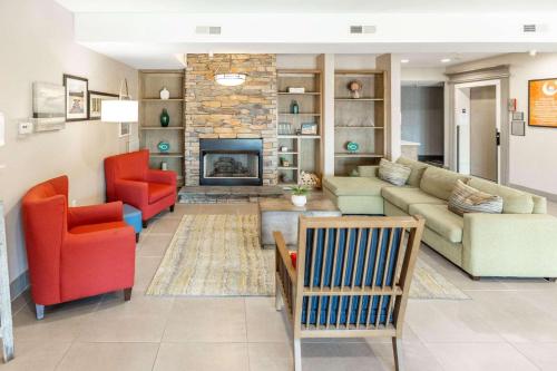 a living room with a couch and a fireplace at Country Inn & Suites by Radisson, Smyrna, GA in Smyrna