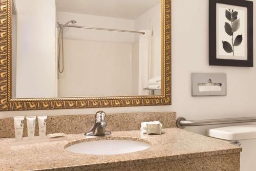 a bathroom with a sink and a mirror at Country Inn & Suites by Radisson, Conyers, GA in Conyers