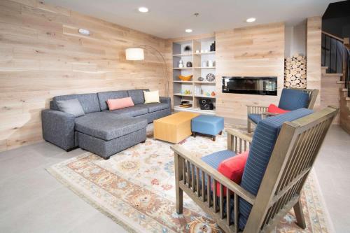 a living room with a couch and a table and a tv at Country Inn & Suites by Radisson, Stone Mountain, GA in Stone Mountain