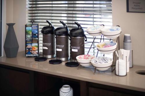 a counter with a shelf with bowls and appliances at Country Inn & Suites by Radisson, Stone Mountain, GA in Stone Mountain