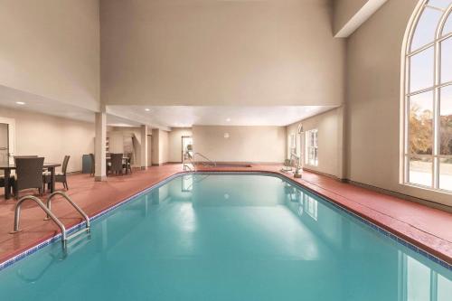 a swimming pool in a hotel room with a large window at Country Inn & Suites by Radisson, Griffin, GA in Griffin