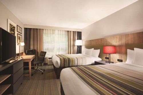 Pokój hotelowy z 2 łóżkami i biurkiem z komputerem w obiekcie Country Inn & Suites by Radisson, Newnan, GA w mieście Newnan