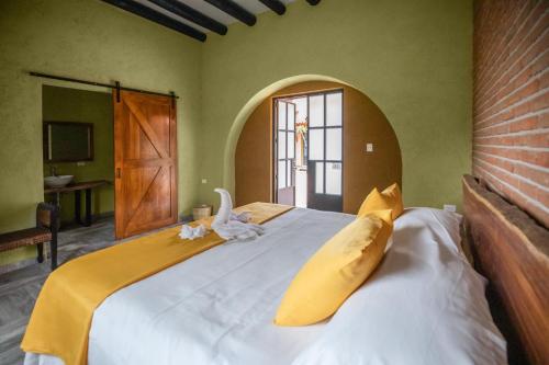 a bedroom with a large bed with a swan on it at Hacienda Gamboa in Atlixco