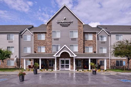 a large building with a sign on the front of it at Country Inn & Suites by Radisson, Omaha Airport, IA in Omaha