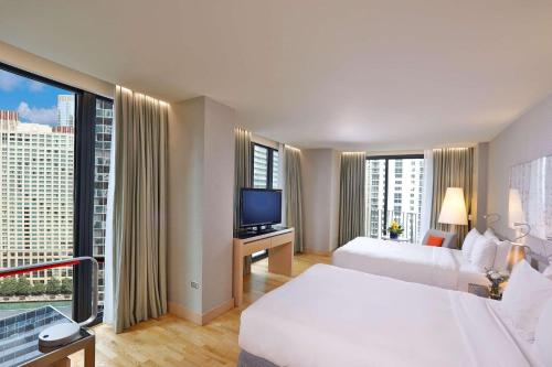 a hotel room with two beds and a flat screen tv at Radisson Blu Aqua Hotel, Chicago in Chicago