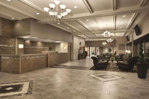 a lobby with a waiting room with chairs and a reception at Radisson Hotel Louisville North in Jeffersonville