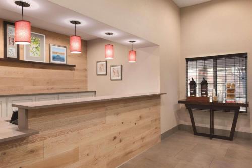 a bar in a restaurant with red lights at Country Inn & Suites by Radisson, Merrillville, IN in Merrillville