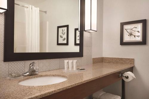 a bathroom with a sink and a mirror at Country Inn & Suites by Radisson, Valparaiso, IN in Valparaiso