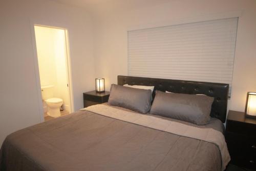 a bedroom with a large bed with two pillows at Ocean Way One Bedroom in Los Angeles