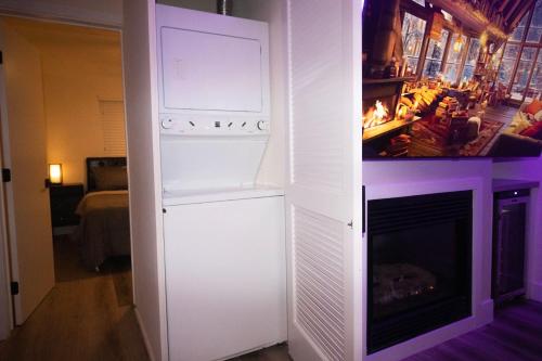 a white refrigerator in a living room with a fireplace at Ocean Way One Bedroom in Los Angeles