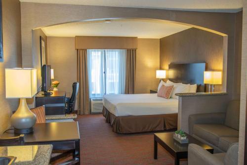 una camera d'albergo con letto e soggiorno di Country Inn & Suites by Radisson, Garden City, KS a Garden City