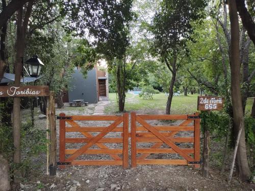 a wooden gate in a park with trees at Las Toribias I in Merlo