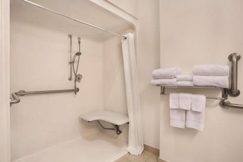 a bathroom with a shower and white towels at Country Inn & Suites by Radisson, Bowling Green, KY in Bowling Green