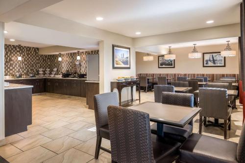 um restaurante com mesa e cadeiras e um bar em Country Inn & Suites by Radisson, Grandville-Grand Rapids West, MI em Grandville