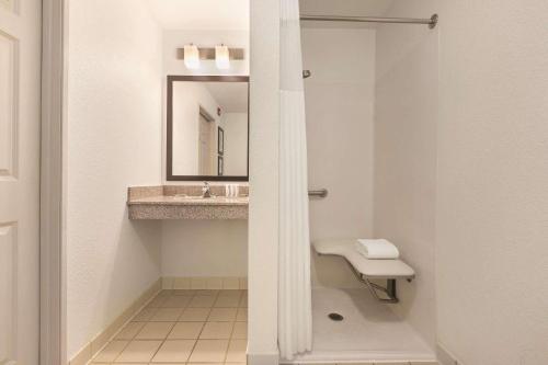 a bathroom with a sink and a mirror at Country Inn & Suites by Radisson, Willmar, MN in Willmar