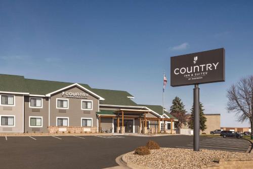 a sign in front of a country inn and suites at Country Inn & Suites by Radisson, Northfield, MN in Northfield