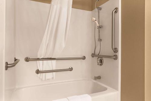 a bathroom with a bath tub with two towel bars at Country Inn & Suites by Radisson, Albert Lea, MN in Albert Lea
