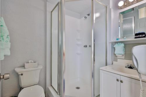 a bathroom with a shower and a toilet and a sink at Coastal Waters 106 - A 1-1 Pool Side Retreat in New Smyrna Beach