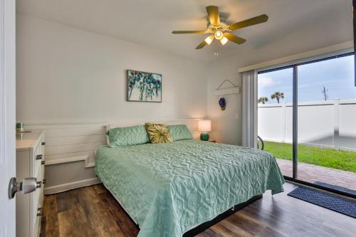 a bedroom with a bed and a ceiling fan at Coastal Waters 106 - A 1-1 Pool Side Retreat in New Smyrna Beach