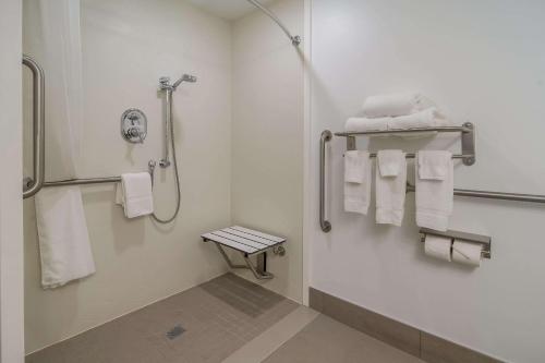 a bathroom with white towels and a shower at Country Inn & Suites by Radisson, Goldsboro, NC in Goldsboro