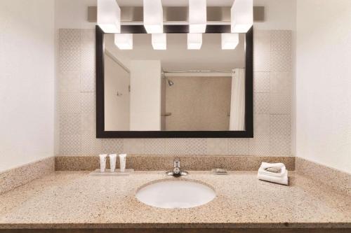 a bathroom with a sink and a mirror at Country Inn & Suites by Radisson, Boone, NC in Boone