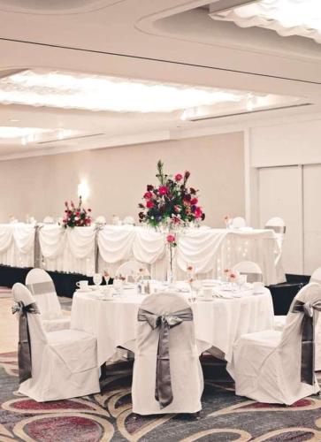 a banquet room with white tables and white chairs at Radisson Hotel Corning in Corning