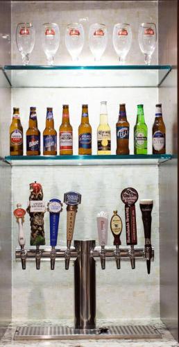 a display of different types of beer bottles and glasses at Radisson Hotel Corning in Corning