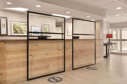 an office with sliding glass doors in a lobby at Country Inn & Suites by Radisson, Port Clinton, OH in Port Clinton