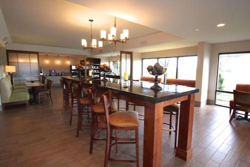 a living room with a large island in a house at Country Inn & Suites by Radisson, Sandusky South, OH in Milan