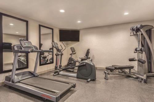 a gym with two treadmills and two machines at Country Inn & Suites by Radisson, Erie, PA in Erie