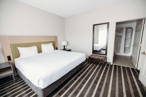 a hotel room with a large bed and a window at Parkview Inn & Suites, Lancaster Amish Country, PA in Lancaster
