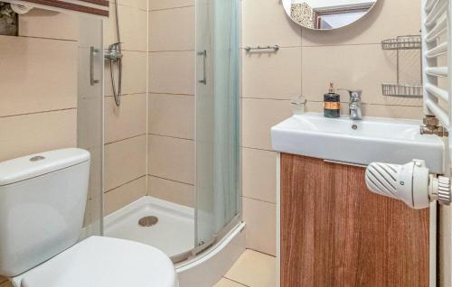 a bathroom with a toilet and a sink at Awesome Apartment In Zarnowska With Heated Swimming Pool in Żarnowska