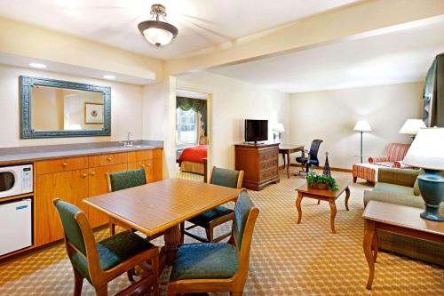 a living room with a dining table and a living room at Country Inn & Suites by Radisson, York, PA in York