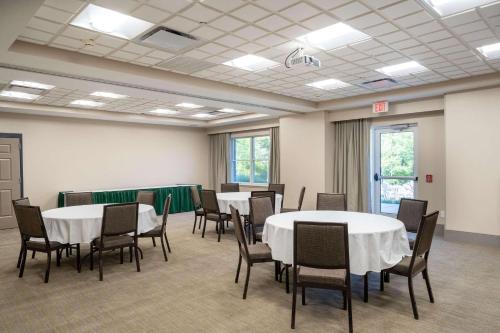 a conference room with tables and chairs in it at Country Inn & Suites by Radisson, State College Penn State Area , PA in State College