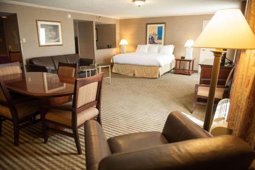 a hotel room with a bed and a couch and a table at Radisson Hotel Philadelphia Northeast in Trevose