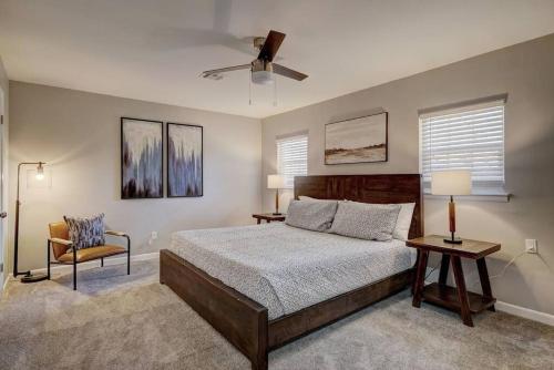 um quarto com uma cama, uma ventoinha e uma cadeira em 4BR Beauty w/ Game Room! Lake Hefner Hideaway em The Village
