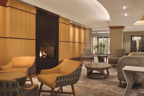 a waiting room with chairs and a fireplace at Radisson Hotel Providence Airport in Warwick