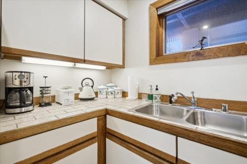 a kitchen with a sink and a coffee maker at Ski on ski off, conveniently located, 2 bedroom condo with beautiful views, access to indoor pool Sunrise B3 in Killington
