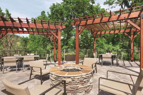 a patio with a fire pit and tables and chairs at Country Inn & Suites by Radisson, Pigeon Forge South, TN in Pigeon Forge