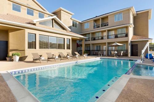 a swimming pool in front of a house at Country Inn & Suites by Radisson, Fort Worth West l-30 NAS JRB in Fort Worth