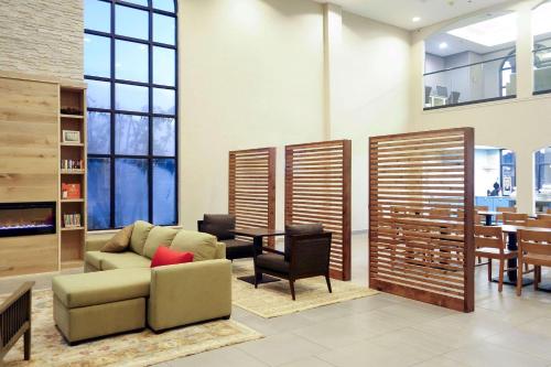 a living room with a couch and a table at Country Inn & Suites by Radisson, Houston Northwest, TX in Houston